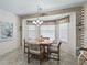 Inviting dining area featuring a bay window, brick accents, and a charming chandelier at 2256 Margarita Dr, The Villages, FL 32159