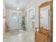 Bright foyer with tiled floor, decorative front door, and charming decor details at 2256 Margarita Dr, The Villages, FL 32159