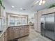 Modern kitchen featuring granite countertops, stainless steel refrigerator, and eat-in breakfast nook at 2256 Margarita Dr, The Villages, FL 32159