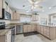 Well-equipped kitchen with granite counters, stainless steel appliances, and light-colored cabinetry at 2256 Margarita Dr, The Villages, FL 32159