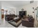 Comfortable living room with plush leather seating, a modern media center, and neutral decor at 2256 Margarita Dr, The Villages, FL 32159