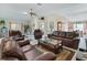 Open-concept living area with hardwood floors, comfortable sofas, and decorative accents throughout at 2256 Margarita Dr, The Villages, FL 32159