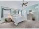 Serene bedroom with a ceiling fan, a large bed, neutral tones, and lots of natural light at 2256 Margarita Dr, The Villages, FL 32159