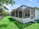 Screened in porch on a lush green lawn, perfect for enjoying the outdoors bug-free at 2256 Margarita Dr, The Villages, FL 32159