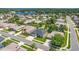 Aerial view of home in a neighborhood near a lake at 25524 Maurepas Ln, Leesburg, FL 34748