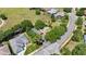 Aerial view of the community featuring a red car parked in the lot of a community building at 25524 Maurepas Ln, Leesburg, FL 34748