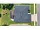 Aerial view of home showcasing the roof and screened enclosure at 25524 Maurepas Ln, Leesburg, FL 34748