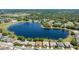 Beautiful aerial view of homes surrounding a scenic lake, showcasing a serene community and lush greenery at 25524 Maurepas Ln, Leesburg, FL 34748