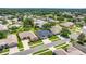 Aerial view of a home in a neighborhood with mature trees and landscaping at 25524 Maurepas Ln, Leesburg, FL 34748