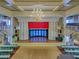 Elegant auditorium with a large stage, grand chandelier, seating, and a piano, perfect for events at 25524 Maurepas Ln, Leesburg, FL 34748