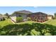 A home featuring a screened-in patio in a well-maintained backyard, ideal for outdoor living at 25524 Maurepas Ln, Leesburg, FL 34748