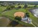 Overhead view of the baseball field and pond in the community with abundant green space and golf course in the background at 25524 Maurepas Ln, Leesburg, FL 34748