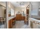 Expansive bathroom features tiled floors, dual vanities, makeup vanity, a separate shower and commode area at 25524 Maurepas Ln, Leesburg, FL 34748