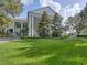 Well-maintained building with classic architectural details, surrounded by a lush green lawn and trees at 25524 Maurepas Ln, Leesburg, FL 34748