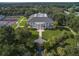 Stunning aerial view of the community clubhouse with lush landscaping and elegant architectural details at 25524 Maurepas Ln, Leesburg, FL 34748