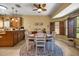 Open dining space with tile flooring, backyard view, and wood furnishings at 25524 Maurepas Ln, Leesburg, FL 34748