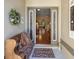 Inviting front entrance with a cozy bench and welcoming decor, leading to the living area at 25524 Maurepas Ln, Leesburg, FL 34748