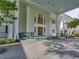 Inviting building entrance with stately columns, ample parking, and accessible features at 25524 Maurepas Ln, Leesburg, FL 34748