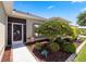 Beautiful front entrance with landscaped garden and decorative door leading to an inviting home at 25524 Maurepas Ln, Leesburg, FL 34748