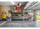 Well organized garage with multiple shelving units for storage at 25524 Maurepas Ln, Leesburg, FL 34748