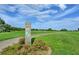 Scenic view of the golf course with lush green fairways, mature trees, and a blue sky at 25524 Maurepas Ln, Leesburg, FL 34748