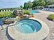 Relaxing community hot tub is surrounded by well-maintained landscaping and brick pavers at 25524 Maurepas Ln, Leesburg, FL 34748