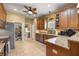 Spacious kitchen with wood cabinets, granite countertops, and stainless steel appliances at 25524 Maurepas Ln, Leesburg, FL 34748