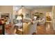 Inviting living room with vaulted ceilings, hardwood floors, and comfortable seating arrangement at 25524 Maurepas Ln, Leesburg, FL 34748