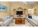 Well-lit living room featuring cozy sofas, and a large entertainment center at 25524 Maurepas Ln, Leesburg, FL 34748