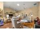 Bright living room with vaulted ceilings, hardwood floors, and stylish coastal décor at 25524 Maurepas Ln, Leesburg, FL 34748