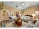 Cozy living room with vaulted ceilings, hardwood floors, and comfortable seating arrangement at 25524 Maurepas Ln, Leesburg, FL 34748