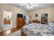 Spacious bedroom with an en-suite bathroom, walk-in closets, and comfortable furnishings at 25524 Maurepas Ln, Leesburg, FL 34748
