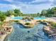 Multi-tiered community pool features serene ponds and landscaping at 25524 Maurepas Ln, Leesburg, FL 34748