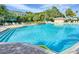Large pool and adjacent seating areas create a resort-like experience for residents at 25524 Maurepas Ln, Leesburg, FL 34748