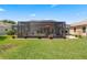 A screened-in patio provides a comfortable, bug-free space to enjoy the outdoors at 25524 Maurepas Ln, Leesburg, FL 34748