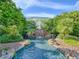 Beautiful waterfall feature and lush greenery add natural beauty to this community's recreational space at 25524 Maurepas Ln, Leesburg, FL 34748