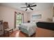 Cozy bedroom with natural light and comfortable decor at 27022 Racquet Cir, Leesburg, FL 34748