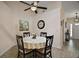 Charming breakfast nook featuring a round table with a floral centerpiece and a ceiling fan at 27022 Racquet Cir, Leesburg, FL 34748