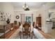Traditional dining room with wood floors, an oval table and chairs, and a decorative chandelier at 27022 Racquet Cir, Leesburg, FL 34748
