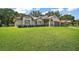 Charming single-story home with a well-manicured lawn and an inviting exterior at 27022 Racquet Cir, Leesburg, FL 34748