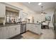Modern kitchen with stainless steel appliances, granite countertops, and an open layout at 27022 Racquet Cir, Leesburg, FL 34748