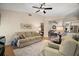 Spacious living room with hardwood floors, comfortable seating, and a relaxing atmosphere at 27022 Racquet Cir, Leesburg, FL 34748