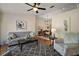 Comfortable living space with hardwood floors, ceiling fan, and an adjacent dining area at 27022 Racquet Cir, Leesburg, FL 34748