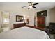 Spacious main bedroom boasts a large bed, ample storage, and access to the ensuite bathroom at 27022 Racquet Cir, Leesburg, FL 34748