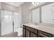 Clean bathroom featuring a tiled shower, dark wood cabinets, and a quartz countertop at 2786 Top Hill Ct, Minneola, FL 34715