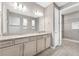 Bright bathroom featuring a double vanity with granite counters and a walk-in shower at 2786 Top Hill Ct, Minneola, FL 34715