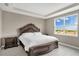 Bedroom featuring a large decorative bed frame and a window with a view at 2786 Top Hill Ct, Minneola, FL 34715