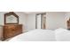 Spacious bedroom featuring a large wood dresser and a bed with white linens at 2786 Top Hill Ct, Minneola, FL 34715