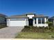 Charming single-story home featuring a neatly landscaped front yard and a two-car garage at 2786 Top Hill Ct, Minneola, FL 34715