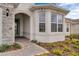 Close up of a charming home's front entrance showing a decorative glass door and neatly manicured landscaping at 2786 Top Hill Ct, Minneola, FL 34715